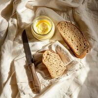 Top view of a jar of ghee and two slices of bread. photo