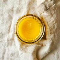 Top view of a jar of ghee on a light background. photo