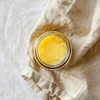 Top view of a jar of ghee on a light background. photo