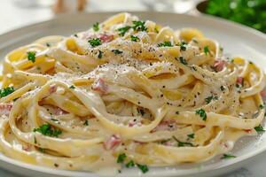 A portion of carbonara pasta in a plate on the table. photo