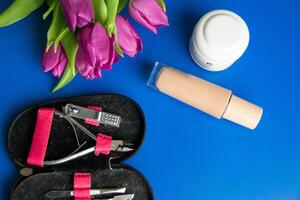 Tools and cosmetics needed for nail styling on a white background. photo