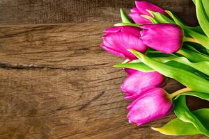 Bouquet of beautiful tulips on wooden background. Tulips on old boards photo