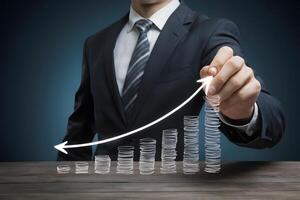 Businessman draws increase arrow graph, symbolizing corporate growth photo