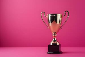 Golden trophy cup on pink background symbolizes victory photo