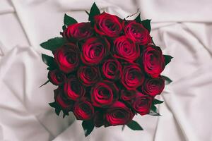 Romantic gesture red rose bouquet isolated on pristine white photo