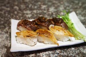 Close up Beef and Engawa, Flounder fin Sushi photo