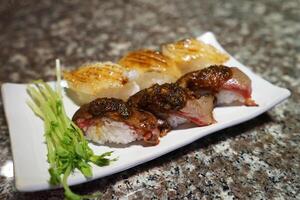 Close up Beef and Engawa, Flounder fin Sushi photo