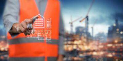 An engineer is inspecting the design and construction of houses and buildings, a builder is looking at a construction model. photo