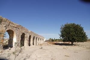 roman aqueduct in antas, spain photo