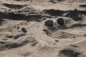 lost sunglasses in the sand photo