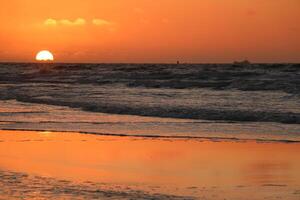 sunset at vlieland, dutch island in the sea photo