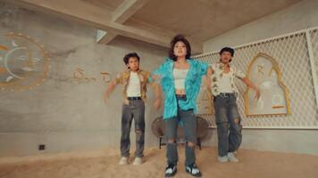 Three young adults dancing in a stylish room with vintage decor. video