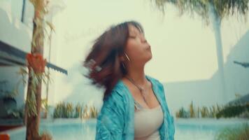 woman in casual attire dancing in an unfinished room with exposed walls and floor, contemplating interior design video