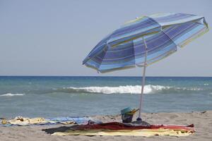 Beach umbrella at the shore photo