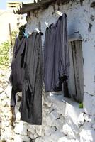 black clothes hanging on the clothesline photo