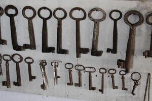 old keys hanging on a wall photo