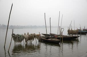 fishing boats on the ganga river, varanasi, india photo