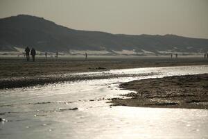 amazing, never seen it before, ice on the salt water and sand, beach, north sea,winter in the netherlands photo