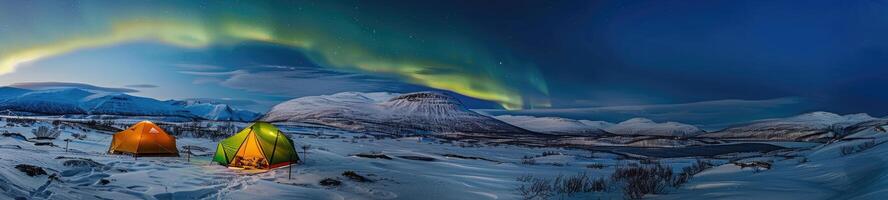 Tents on the snow under the Northern lights photo