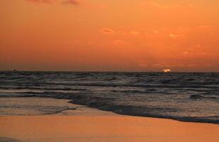 sunset at vlieland, dutch island in the sea photo