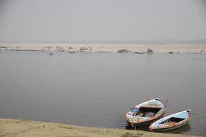 fishing boats on the ganga river, varanasi, india photo