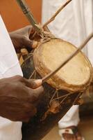 playing drums at festival in Benin photo