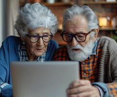 Elderly couple exploring technology together at home photo