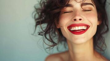 Joyful young woman with windblown hair smiling brightly photo