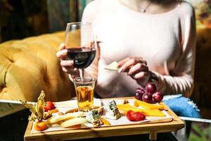 Woman Enjoying a Meal at a Table With Food and Wine photo