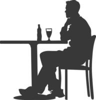 silueta hombre sentado a un mesa en el café negro color solamente vector