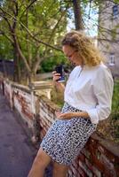 middle age woman in 70s, 80s style clothes spilled coffee on herself during a break outside photo