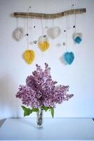 a bouquet of lilacs in a crystal vase in the interior photo