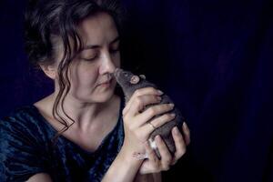 a berkshire standard rat cuddles with its owner photo