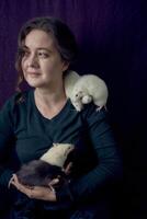 the woman holds all her five rats in her hands photo