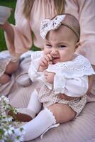 a baby girl eats grapes in her mother's arms photo