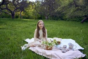 a portrait of a teenage girl in a pastel dress on a picnic photo