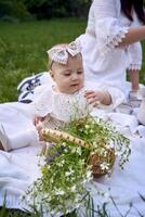 sisters of different ages hug each other tenderly on a picnic in the garden photo