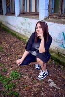 a teenage girl in black clothes in grunge style photo