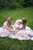 mothers with their tiny baby on a picnic photo