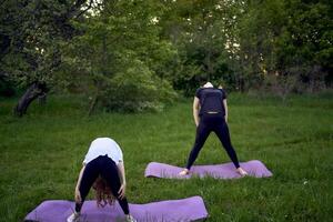 a woman and girl do yoga and meditate in nature photo