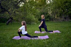 un mujer y niña hacer yoga y meditar en naturaleza foto