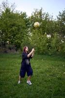 a teenage girl in black plays volleyball photo