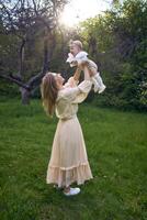 un madre lanza arriba su bebé niña en su brazos foto