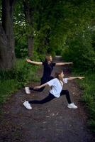 mother and daughter do sports and play in the park photo