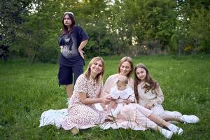 chicas' picnic, todos en pastel vestidos excepto para un Adolescente niña en negro, quien estaba a la fuerza arrastrado a el picnic foto