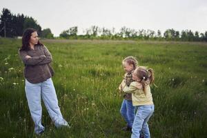 sisters fight over a toy bunny, mother quarrels photo