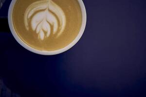 two cups of coffee, latte and cappuccino on a table in a cafe photo