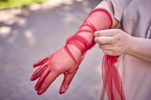 plus size woman in peach fuzz dress and red translucent gloves dancing in the morning city streets photo