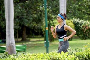 Strong Lady In Gym Outfit Doing Morning Jogging In Park photo