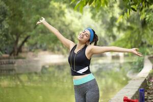 Athletic Woman Breathing Fresh Air At Morning photo